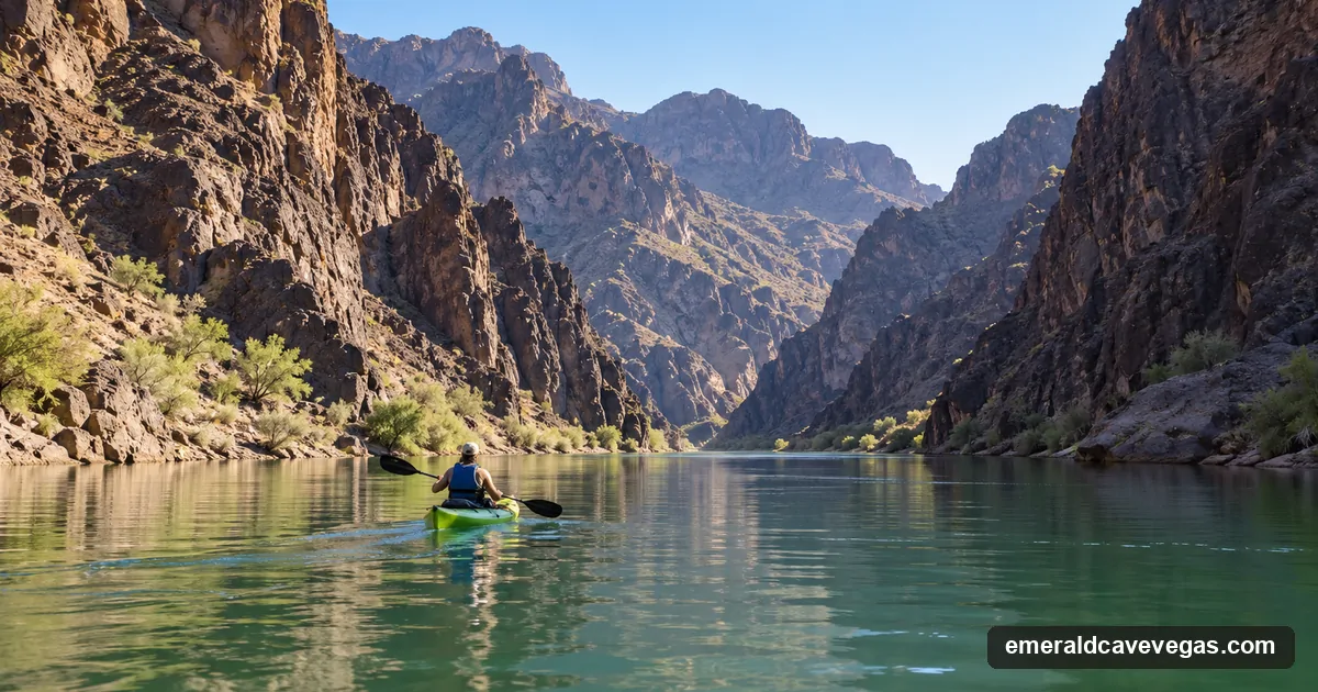 A lone paddler in a rented sit-on-top kayak heading upstream through Black Canyon on calm green water